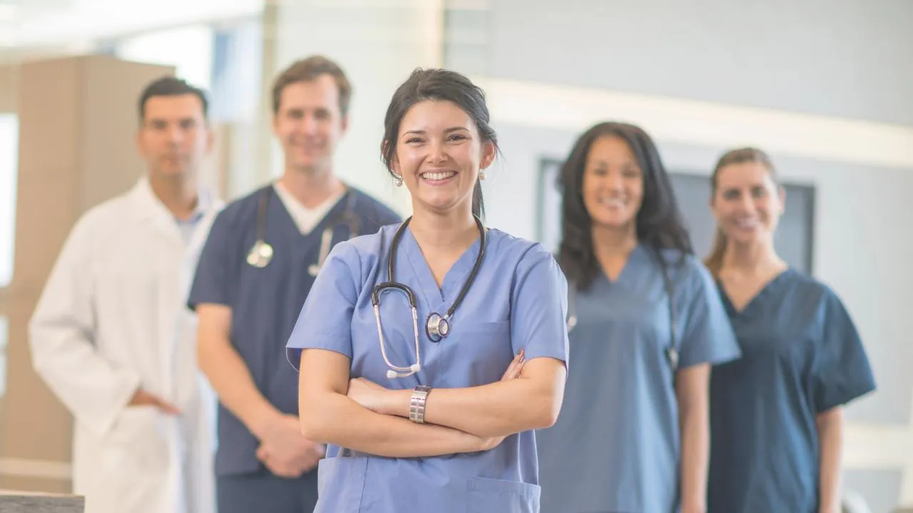A team of nurses standing together and smiling